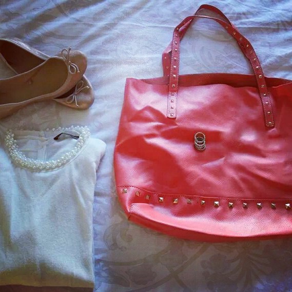 pearl white sweater and coral stud bag
